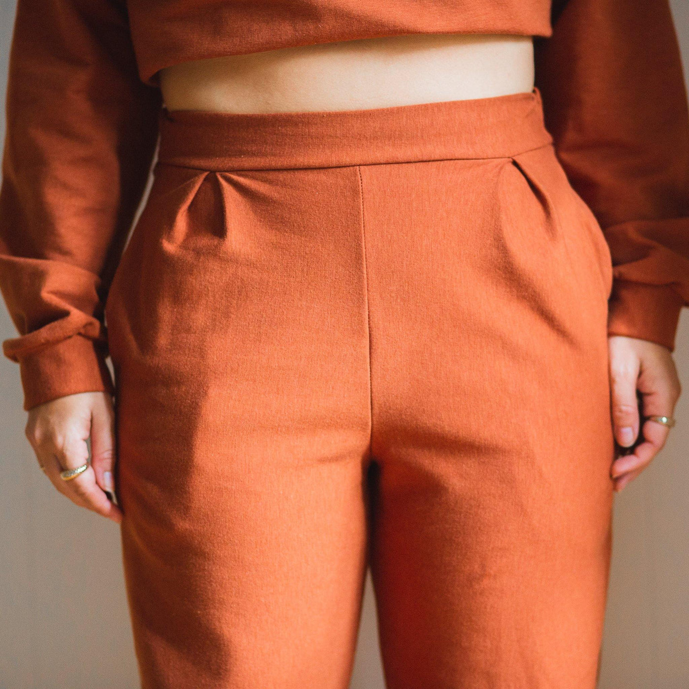 Close up of the waist band of a comfortable orange fleece pants. 